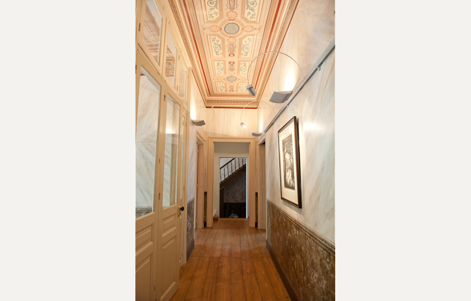 The secondary entrance leads to a beautifully painted corridor